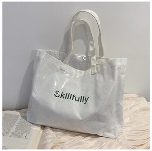 Detail of white canvas tote bag with waterproof clear PVC outer layer and Skillfully print