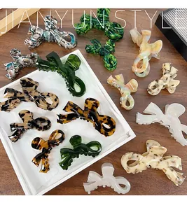 Detail view of assorted acetate bow hair claws in tortoiseshell and marble patterns