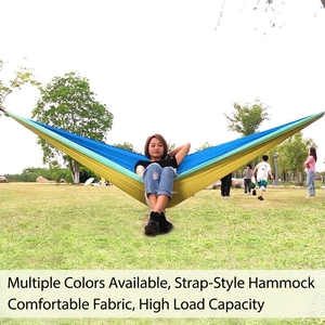 Lightweight nylon camping hammock in blue and yellow bicolor design setup in park