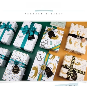 Detail of luxury leopard and floral gift wrapping paper with decorative ribbons and tags