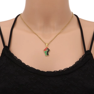 Detail of Pan-African fist pendant necklace in gold finish with red black green enamel