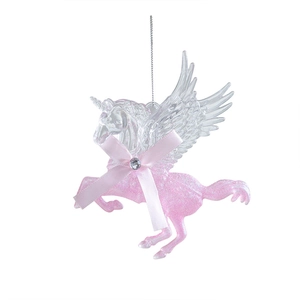 Pink glitter unicorn Christmas ornament with wings and a bow on white background
