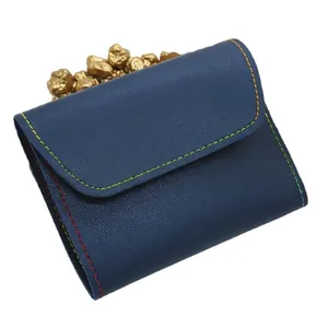 16-piece black manicure set with multi-colored stitching in a navy blue leather case