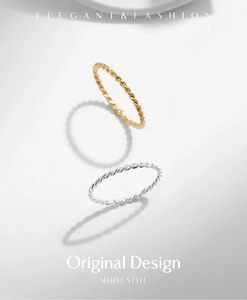 Detail showing minimalist twisted rope rings in gold and silver finish with simple style