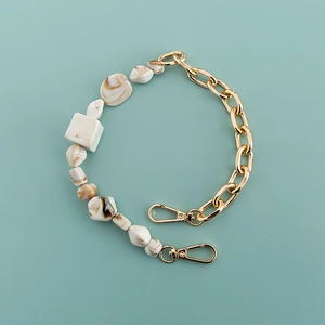 Detail of bohemian acrylic chain strap with marble beads and gold links for phone cases