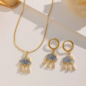 Detailed macro view of the gold chain with blue cloud pendants and zircon water drops