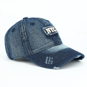 Detail of vintage washed blue baseball cap featuring 3D NYC embroidery and frayed edges