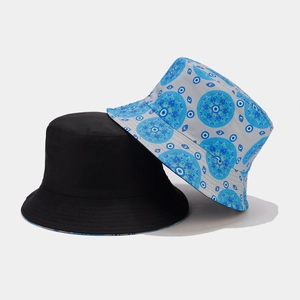 Flat lay of vintage cotton bucket hats featuring solid black and evil eye patterns