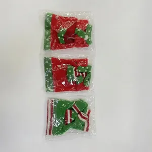 Detail of Christmas wine bottle covers set with Santa embroidery and festive patterns
