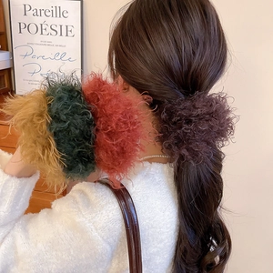 Detailed texture of plush faux fur hair scrunchies in rich autumn colors for women