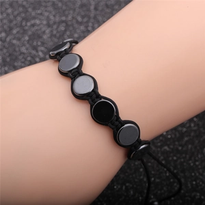 Adjustable black hematite skull braided bracelet featuring polished round stones on wrist