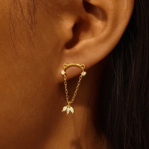 Close-up of gold S925 silver earring with heart crown and marquise cubic zirconia on ear