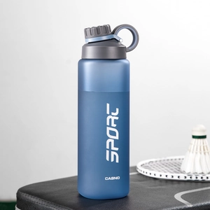 Close-up of frosted blue sport water bottle with matte texture and portable loop cap