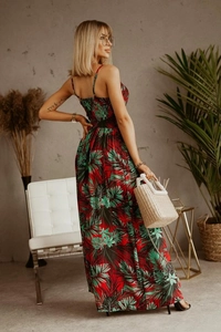 Detail of bohemian maxi dress with tropical leaf print and backless halter design