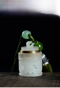 Macro shot of an hollowed-out lotus sandalwood diffuser with green beads and silk tassels