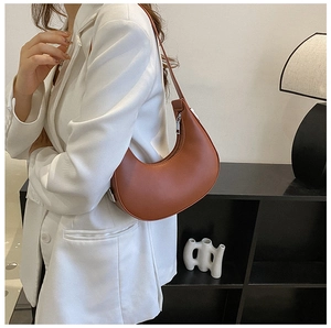 Brown leather hobo bag styled with a white blazer for a chic minimalist daily look