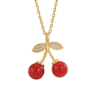 Elegant gold cherry pendant necklace with red beads and sparkling white crystal leaves