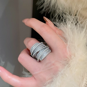 Detailed view of silver layered wide ring with micro-pave zircons and shimmering finish