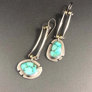 Bohemian silver earrings with irregular turquoise stone inlay on dark gray background