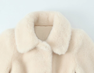 Detail of the high-density faux fur lapel collar on this cream-colored elegant coat