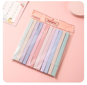 Flat lay of twelve pastel highlighters in a transparent pouch on a pink background
