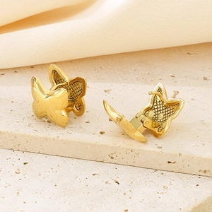 Minimalist gold butterfly hoop earrings made of titanium steel on elegant marble base