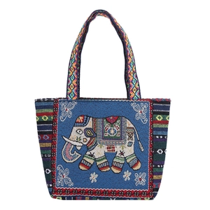 Ethnic blue woven canvas tote bag with colorful elephant patterns and geometric handles