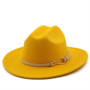 Detail of wool fedora with beige leather band and golden horseshoe buckle on yellow felt