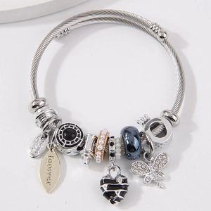 Silver twisted cable bracelet featuring heart, butterfly, and leaf pendants with engraving