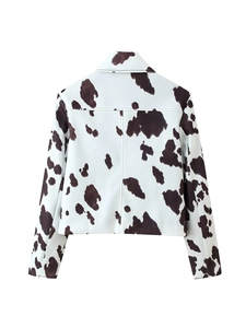 Rear view of casual cow print denim jacket with black spots on a white background
