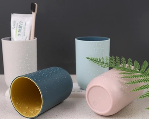 Detail of four colorful plastic mouthwash cups with matte finish and non-slip thick base