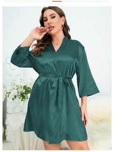 Détail du peignoir en satin vert foncé montrant la texture soyeuse et la ceinture nouée
