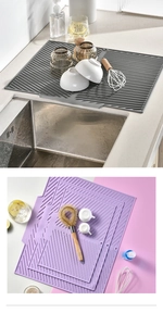 Detail of silicone drying mat featuring non-slip drainage ridges in gray and purple colors