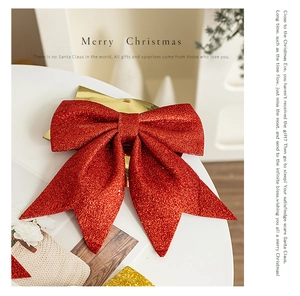 Close-up of red glitter Christmas bow with sparkling texture on a festive white table