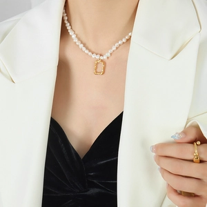 Baroque freshwater pearl necklace with irregular gold pendant on a fashion model