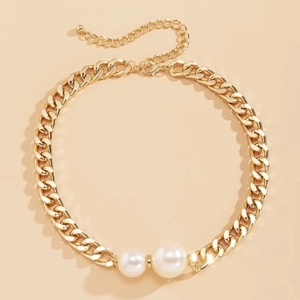 Detail of gold chunky chain necklace featuring faux pearls and adjustable lobster clasp