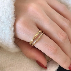 Minimalist double layer golden stainless steel open ring shown on a knitted surface