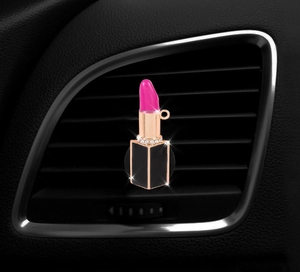Detailed view of pink lipstick car vent clip with sparkling rhinestones and gold accents