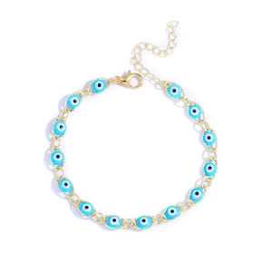 Turkish Evil Eye adjustable gold bracelet with blue resin beads on a white background