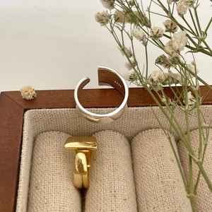 Minimalist 925 sterling silver wide band ring and gold square ring in a jewelry box