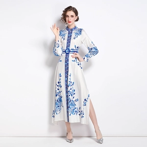 Elegant white long-sleeved dress with blue floral print, mandarin collar and side slit