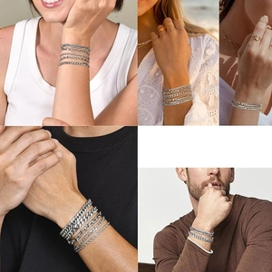 Detail view of silver multi-layer chain bracelet set for men and women on wrist