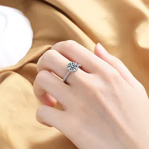 Detailed view of an open heart zircon ring with pavé diamonds on a warm silk background