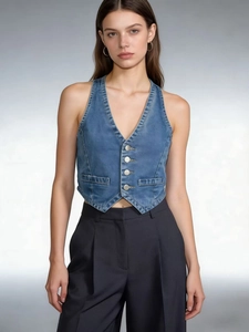 Detail shot of a blue denim waistcoat featuring a deep V-neck and metallic buttons