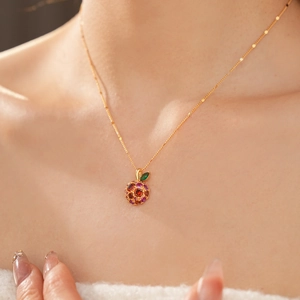 Close-up of 14k gold plated apple pendant necklace with colorful sparkling zircons