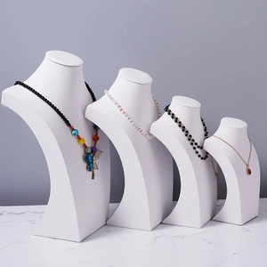 Set of four white leather bust stands in different heights for necklace counter display