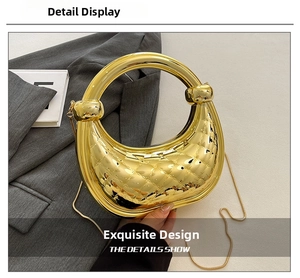 Detail of gold mirror crescent handbag with quilted texture and round metal handle