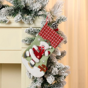 Detail of green velvet Christmas stocking with 3D snowman skating and Merry Christmas sign