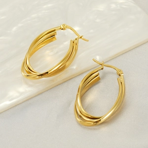 Detail view of gold stainless steel multi-layer hoop earrings with a polished oval finish