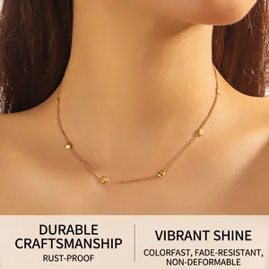 Close-up of a delicate 18K gold plated stainless steel necklace with 3D heart charms